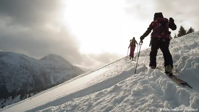 Skiers traverse a slope on a ski touring trek up the Scheinberg mountain