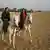 Omar bin Laden and his British wife Jane Felix-Brown ride horses at the site of the Giza Pyramids in Cairo