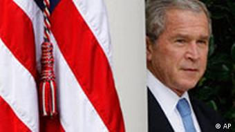 President Bush next to an American flag