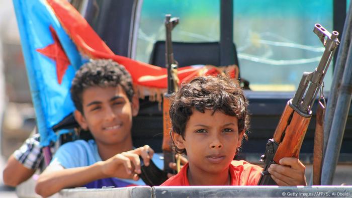 rmed Yemeni children sit in the back of a pick up truck with fighters loyal to Yemen's Saudi-backed government