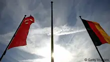 COLOGNE, GERMANY - FEBRUARY 10: Turkish and German flags are seen in front of the KoelnArena prior to a speach of the Turkish Prime Minister Recep Tayyip Erdogan at the KoelnArena to the in Germany living Turks on February 10, 2008 in Cologne, Germany. Erdogan is in Germany to attend the Security Conference and he visited the burned down apartment building in Ludwigshafen where nine Turkish people died. (Photo by Vladimir Rys/Getty Images)