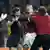 Ein Fan attackiert den deutschen Schiedsrichter Herbert Fandel. Quelle: AP