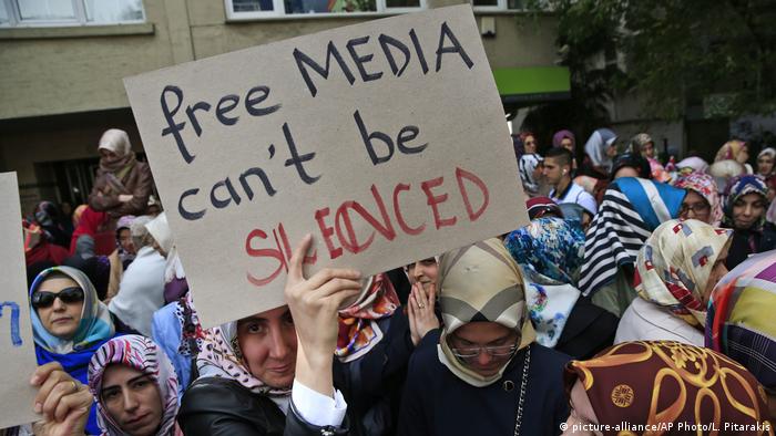 Protesters holding placards reading 'free media can't be silenced' in central Istanbul,