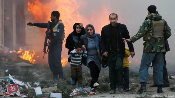 Survivors of an attack in Kabul move away from the ensuing blaze (Reuters/M. Ismail)