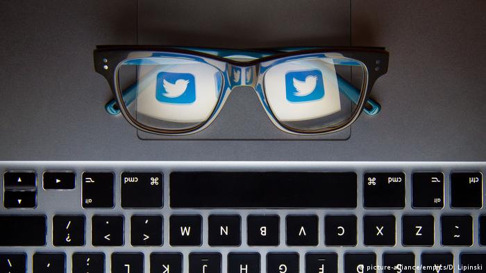 Eyeglasses reflecting the Twitter logo