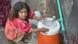 A girl fills a bottle in Pakistan A girl fills a bottle in Pakistan