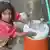 A girl fills a bottle in Pakistan 