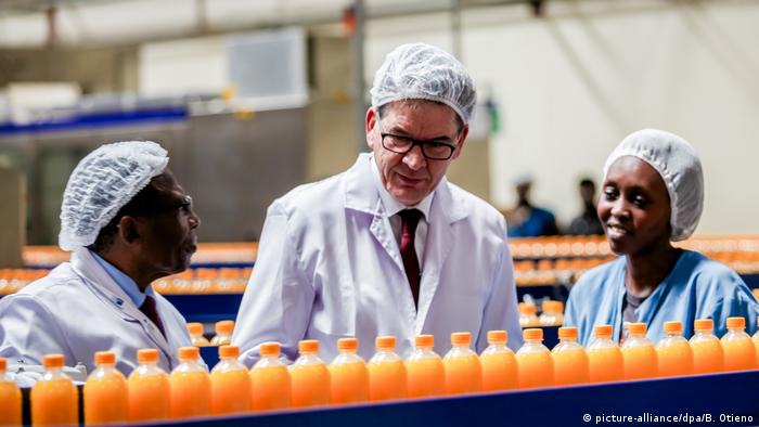 Germany's Development Minister Gerd Müller at a juice factory with workers in Kenya