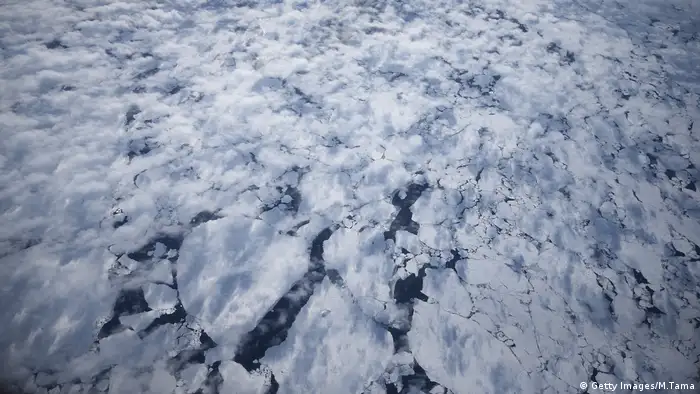 Broken sea ice can be seen through light cloud cover mid-flight during last season's Operation IceBridge near the cost of West Antarctica on October 28, 2016.