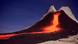 Volcano in front of evening sky: bright red-orange lava flows out Volcano in front of evening sky: bright red-orange lava flows out
