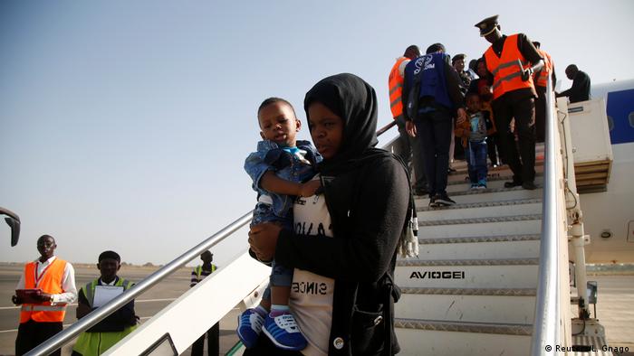 Gambian migrants deported from Libya arrive at the airport in Banjul, Gambia