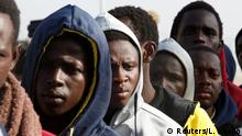 04.04.2017*****REFILE - CLARIFYING CAPTIONGambian migrants who voluntarily returned from Libya stand in line as they wait for registration at the airport in Banjul, Gambia April 4, 2017. REUTERS/Luc Gnago
