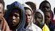 Gambian migrants who voluntarily returned from Libya stand in line as they wait for registration at the airport in Banjul Gambian migrants who voluntarily returned from Libya stand in line as they wait for registration at the airport in Banjul