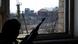 A man with a rifle in a window of a house in the village of Kominternovo after a shelling attack A man with a rifle in a window of a house in the village of Kominternovo after a shelling attack