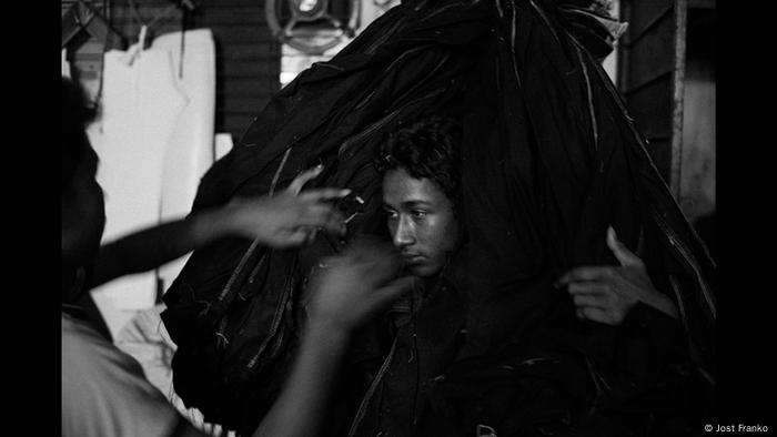 Garment worker carrying jeans - B&W photo by Jost Franko (Jost Franko )