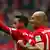 Bayern Munich's Thiago Alcantara celebrates scoring their second goal with Arjen Robben