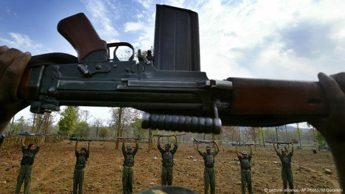 Maoist rebels raise their arms during an exercise at a temporary base in the Abujh Marh forests, in the central Indian state of Chhattisgarh