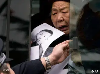 一位女性访民在北京外交部楼外抗议，警察强行关闭她所在的汽车车窗（资料图片：2008年）