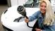 Eine Frau kniet neben ihrem Auto und hält einen Stecker in der Hand (Foto: dpa) Eine Frau kniet neben ihrem Auto und hält einen Stecker in der Hand (Foto: dpa)