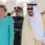 Saudi Arabia's King Salman bin Abdulaziz Al Saud stands next to German Chancellor Angela Merkel during a reception ceremony in Jeddah