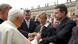 Britain's Kate (C) and Gerry McCann (R), the parents of abducted four year old Madeleine McCann, show the pH๏τo of their daughter to Pope Benedict XVI (L) at the end of weekly general audience in Saint Peter's Square in Vatican on 30 May 2007.
