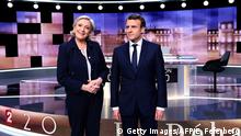 French presidential election candidate for the far-right Front National (FN) party, Marine Le Pen (L) and French presidential election candidate for the En Marche ! movement, Emmanuel Macron pose prior to the start of a live brodcast face-to-face televised debate in television studios of French public national television channel France 2, and French private channel TF1 in La Plaine-Saint-Denis, north of Paris, on May 3, 2017 as part of the second round election campaign.
Pro-EU centrist Emmanuel Macron and far-right leader Marine Le Pen face off in a final televised debate on May 3 that will showcase their starkly different visions of France's future ahead of this weekend's presidential election run-off. / AFP PHOTO / POOL / Eric FEFERBERG (Photo credit should read ERIC FEFERBERG/AFP/Getty Images)