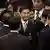 Democrat Party leader Abhisit Vejjajiva, center, is congratulated by lawmakers after being chosen the country's new PM