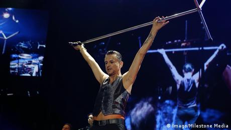 Depeche Mode, Sänger Dave Gahan hält Mikroständer hoch über dem Kopf (Imago/Milestone Media)