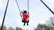 A young girl playing on a swing A young girl playing on a swing