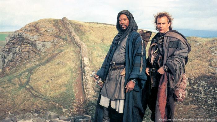 Film still from 'Robin Hood': Morgan Freeman and Kevin Castner wearing medieval capes in a mountainous landscape.