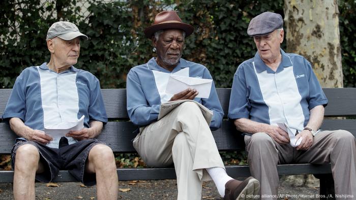 Film still from 'Going in Style': Alan Arkin, Morgan Freeman and Michael Cain sitting on a bench.