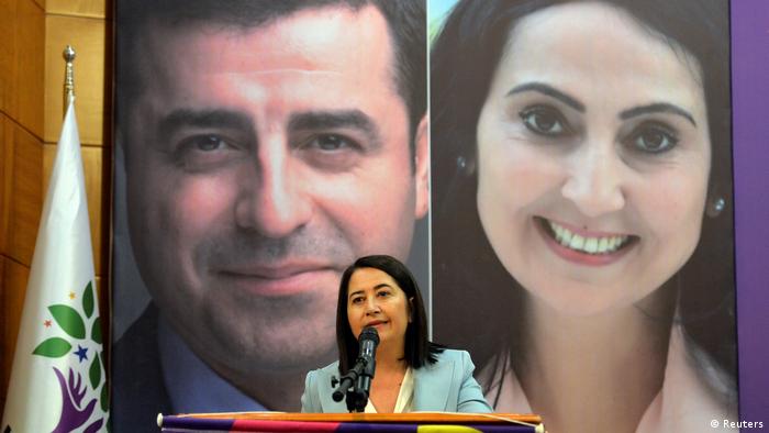 Serpil Kemalbay, of the Pro-Kurdish Peoples' Democratic Party (HDP), speaks during her party's extraordinary congress in Ankara. Posters of the imprisoned co-chairs of the party Selahattin Demirtas and Figen Yuksekdag are seen in the background