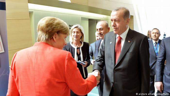 Merkel and Erdogan shake hands
