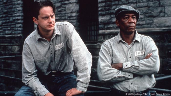 Film still from 'The Shawshank Redemption': Tim Robbins and Morgan Freeman as inmates look on seriously.