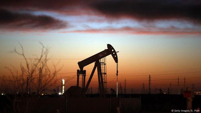 An oil pumpjack is silhouetted against the Texas morning sky An oil pumpjack is silhouetted against the Texas morning sky