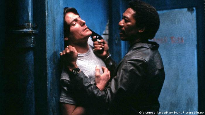 A still from 'Street Smart': Morgan Freeman points a gun to Christopher Reeve's face.