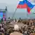 People watch TV address by Vladimir Putin in Crimea