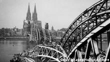+++ Bildergalerie Kölner Bombennacht +++ A view from the west side of the River Rhine showing a bomb damaged Hohenzollern Bridge and Cologne Cathedral in the distance. (Photo by Hulton Archive/Getty Images)