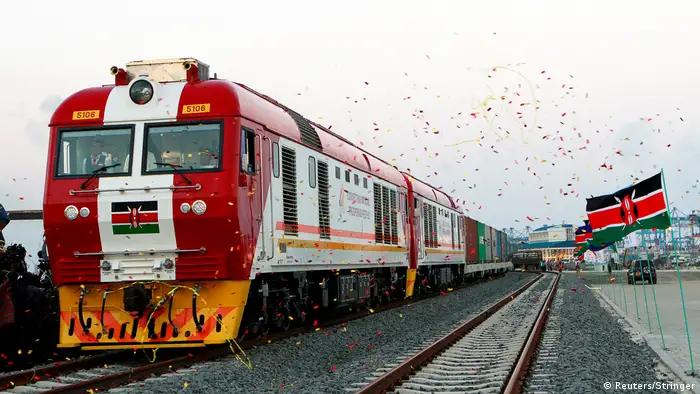 Kenya's Madaraka Express: the red train being inaugurated with confetti and the Kenyan flag. 