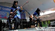 Widi Rahmawati (L) and Firdda Kurnia, members of the metal Hijab band Voice of Baceprot, perform during a school's farewell event in Garut, Indonesia, May 15, 2017. Picture taken May 15, 2017. REUTERS/Yuddy Cahya FOR EDITORIAL USE ONLY. NO RESALES. NO ARCHIVES. TPX IMAGES OF THE DAY