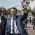 Presidente Emmanuel Macron (c.) deixa seção eleitoral após votar no pleito legislativo