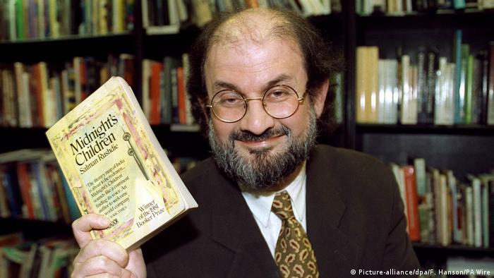 Salman Rushdie with his book Midnight's Children.