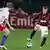Milan's David Beckham, right, controls the ball as Marcell Jansen of Hamburg tries to close him down during the friendly soccer match between AC Milan and Hamburg SV in Dubai, Jan. 6