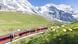 Trem diante de montanha com neve na Suíça