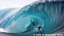 TEAHUPOO REEF - JUNE 1: United States Garrett McNamara (L) and United States Mark Healey (R) compete during a free session of surf tow in, in the southern Pacific ocean island of Tahiti, French Polynesia, on June 1, 2013 in Teahupoo. (Photo by GREGORY BOISSY/AFP/Getty Images)