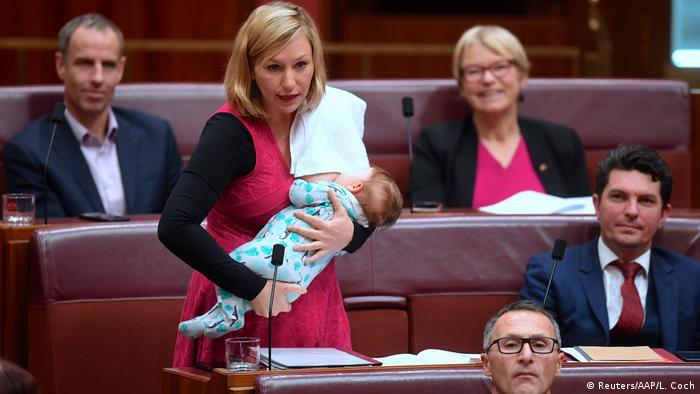 Australian Senator Larissa Waters of the Greens Party breastfeeds her daughter Alia Joy as she speaks in the Australian Senate