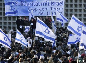 Pro-Israel demonstraters in Berlin wave Israeli flags