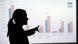 Silhouette of a woman pointing to a graph Silhouette of a woman pointing to a graph