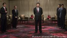 China's President Xi Jinping, center, waits to meet with Hong Kong's outgoing Chief Executive Leung Chun-ying at a hotel in Hong Kong Thursday, June 29, 2017. Xi was greeted by supporters waving red Hong Kong and Chinese flags as he arrived Thursday to mark two decades since China took control of the former British colony and to inaugurate new Chief Executive Carrie Lam on July 1. (Dale de la Rey/Pool Photo via AP) |