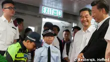 30.06.2017*****A member of the Hong Kong Police Force Junior Police Scheme bows to outgoing Hong Kong Chief Executive Leung Chun-ying and Chinese President Xi Jinping at the Hong Kong Police Force's Junior Police Call Permanent Activity Centre and Integrated Youth Training Camp, Pat Heung, New Territories, Hong Kong, China, 30 June 2017. REUTERS/Alex Hofford/Pool